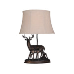 Sculpted Deer Table Lamp with Bronze Finish and Beige Linen Shade